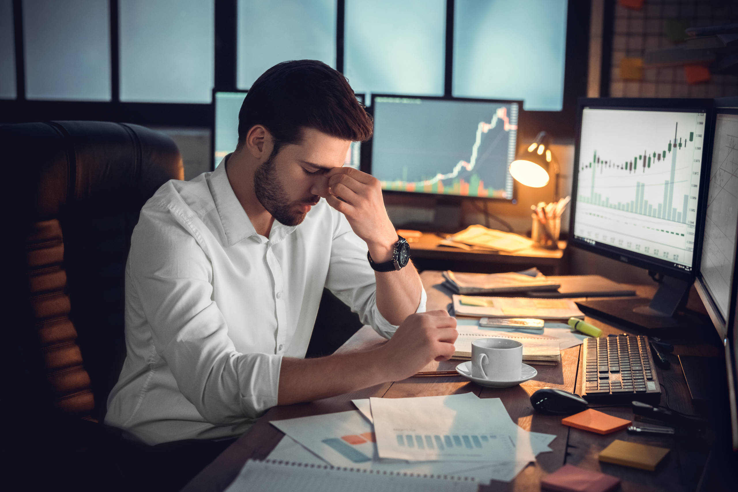 Depressed frustrated trader tired of overwork or stressed by bankruptcy Depressed frustrated trader tired of overwork or stressed by bankruptcy